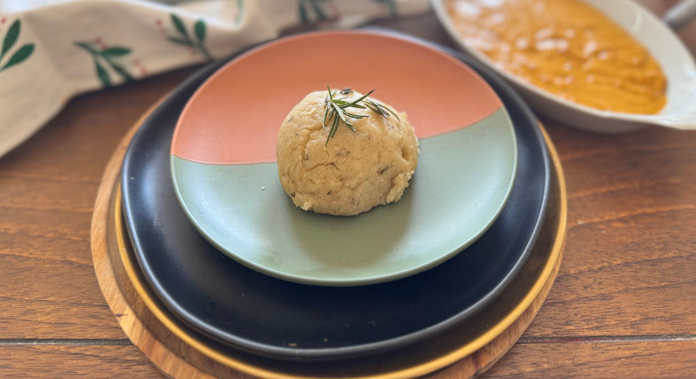 Image of gluten-free garlic herb dinner roll served on a plate, a soft vegan and dairy-free bread made with herbs.